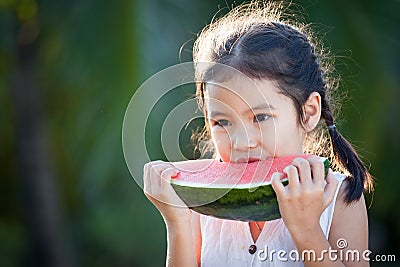 Cute asian little child girl eating watermelon fresh fruit Stock Photo