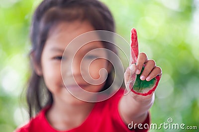 Asian little child girl with painted hands showing fingers number one Stock Photo