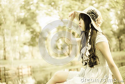 A cute Asian Thai girl is looking in the sky with hope Stock Photo