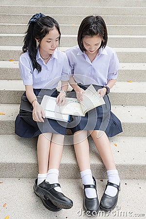 Cute Asian Thai high schoolgirls student couple reading Stock Photo