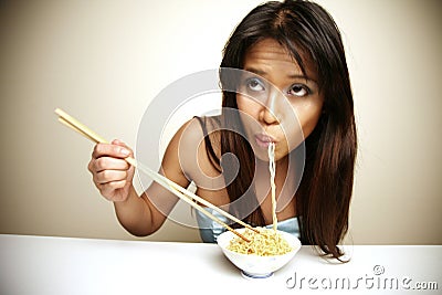 Cute Asian woman eating noodles Stock Photo