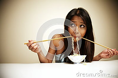 Cute Asian woman eating noodles Stock Photo