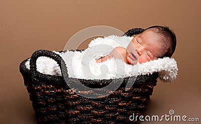 Cute baby asleep in basket Stock Photo