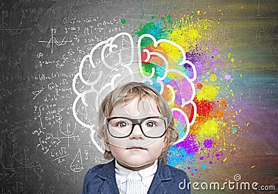 Cute baby boy in glasses and colorful brain sketch Stock Photo