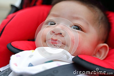 Cute baby boy happy playful bubbles saliva drool on child mouth Stock Photo