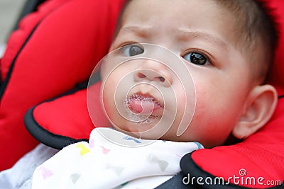 Cute baby boy happy playful bubbles saliva drool on child mouth Stock Photo