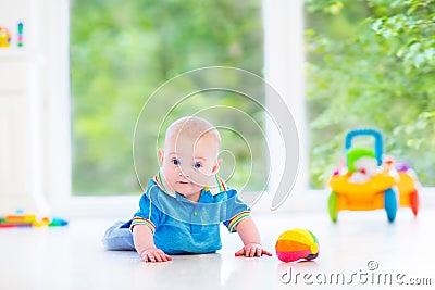 Cute baby boy playing with colorful ball and toy car Stock Photo