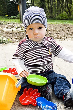 Cute Baby Boy Playing Outdoors Stock Photo