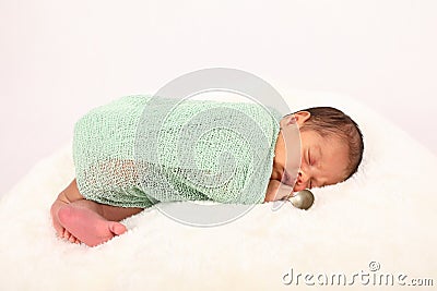 Cute baby boy in wrap - born with silver spoon Stock Photo