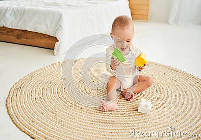 A kid playing toy blocks inside his house Stock Photo