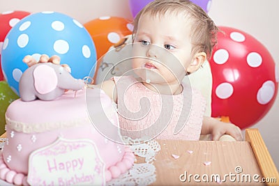 Cute baby celebrating first birthday and eating cake. Stock Photo