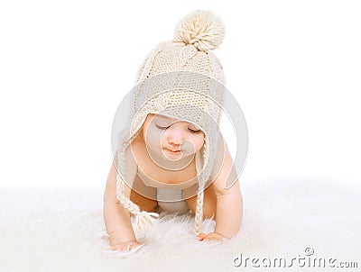 Cute baby in comfort knitted hat crawling Stock Photo