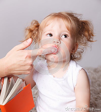 Cute baby getting her teeth brushed Stock Photo
