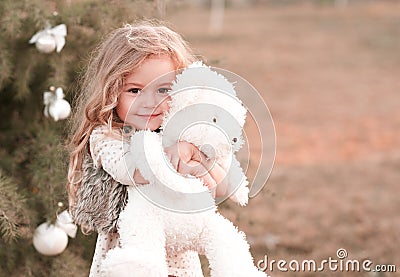 Cute baby girl holding bear toy Stock Photo