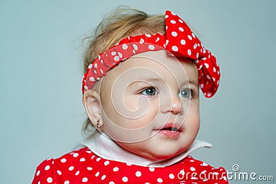 Cute baby girl red polka dot bow on head. Fashion accessory. Fashion for babies. Stylish toddler adorable girl. Happy Stock Photo