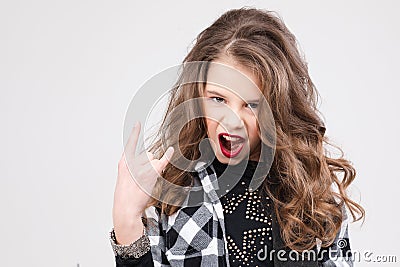 Cute baby girl rock star playing electric guitar and singing song surrounded by balloons Stock Photo