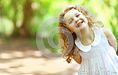 Cute baby girl shone with happiness, curly hair Stock Photo