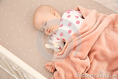 Cute baby girl sleeping in crib. Bedtime Stock Photo