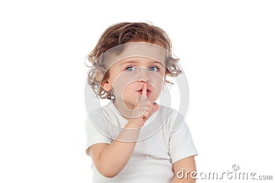Cute baby has put forefinger to lips as sign of silence Stock Photo