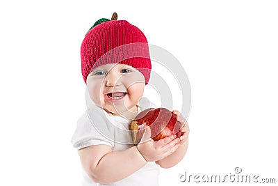 Cute baby in a knitted apple hat biting in a red ripe apple, isolated on white Stock Photo