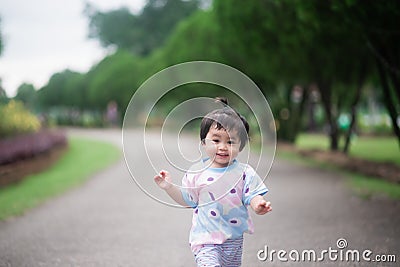 Cute baby running in the garden Stock Photo