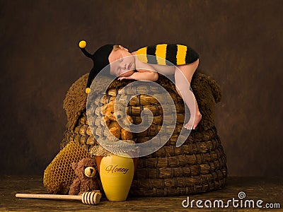 Cute baby sleeping on beehive Stock Photo