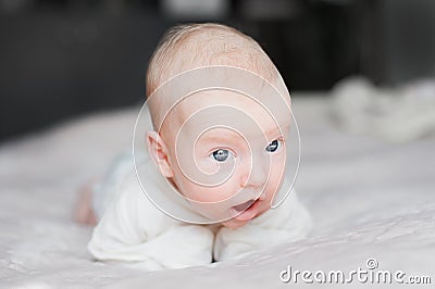 Cute baby on the white bed Stock Photo