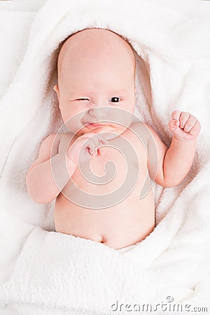 Cute baby wrapped into towels Stock Photo