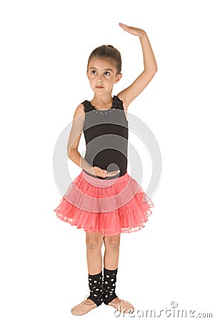 Cute ballerina girl posing in dance position in pink tutu Stock Photo