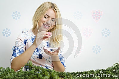 Cute, beautiful blonde eating tasty macaroon cookie Stock Photo