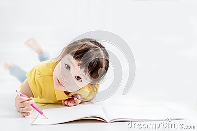 Cute beautiful little girl drawing on the flloor Stock Photo