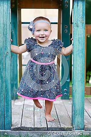 Cute beautiful smiling little girl on a playground Stock Photo