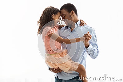 Cute black father and daughter dancing over white Stock Photo