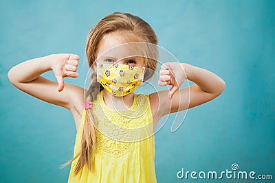 Cute blond preteen girl in antiviral medical mask shows stop gesture. Stock Photo