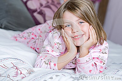 Cute Blonde Child Lying on her Bed Stock Photo