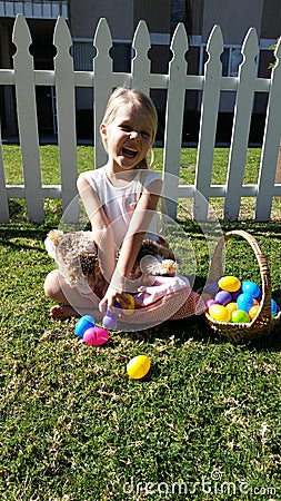 Smiling blonde girl with Easter egg basket Stock Photo