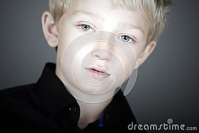 Cute Blonde Haired Boy Looking Pensive Stock Photo