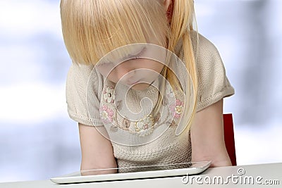 Cute blonde little girl with digital tablet Stock Photo