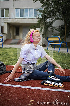 Teen Music And Happy Mood. Adolescent Music In Headphones. Cheerful Happy Girl Outdoor. Stock Photo