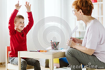 Cute boy with ADHD during session with professional therapist Stock Photo