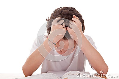 Cute boy on the desk studying and despairing Stock Photo