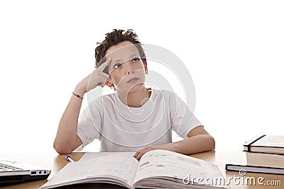 Cute boy on the desk studying and thinking Stock Photo