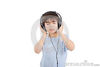 Cute boy is listening to music with eyes closed Stock Photo