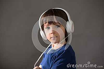 Cute boy with phone and head phones, listening music Stock Photo