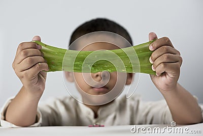 Cute boy playing with slime Stock Photo