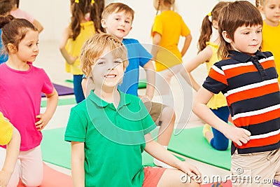 Cute boy practicing gymnastics in children`s group Stock Photo