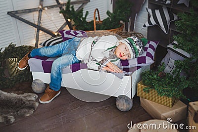 Cute boy sleeps on a bed in a decorated studio Stock Photo