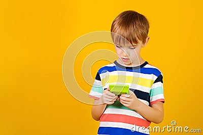 Cute boy using a calculator. Back to school concept. Kid solves a math task with calculator Stock Photo