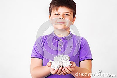 Cute boy holding paper bin full of crumpled papers surprised with an idea. promoting recycling of used paper Stock Photo