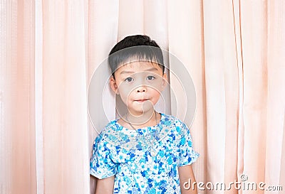 Cute boy wear flower shirt on pink curtain background Stock Photo